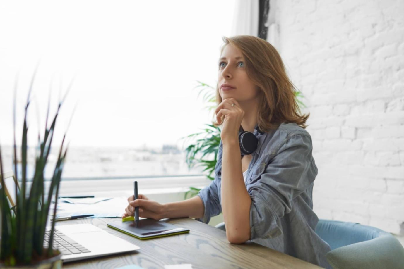 Writer at a desk, illuminated by soft light